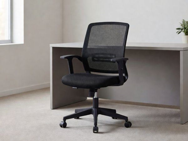 Affordable black mesh office chair in a modern room